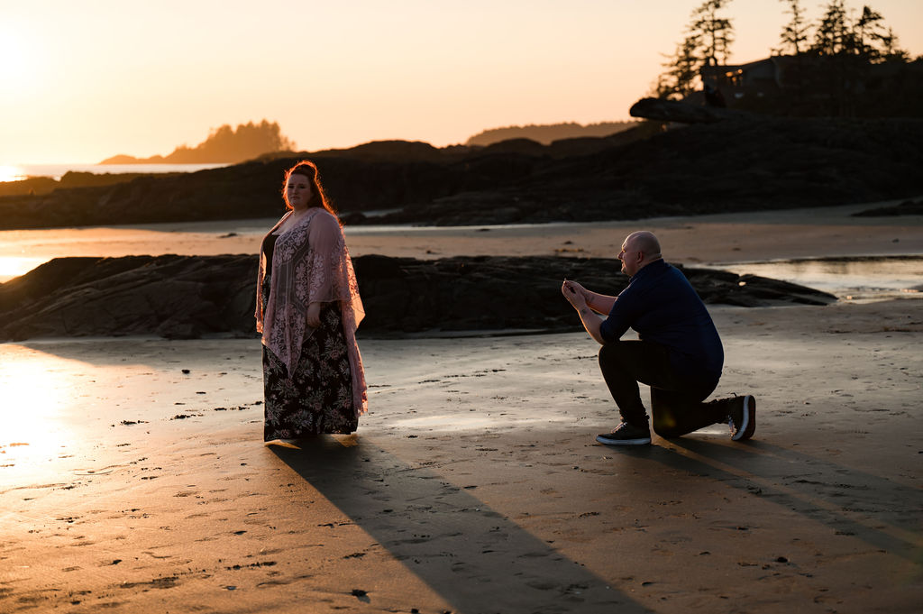 Man proposes to his girlfriend at sunset in Tofino